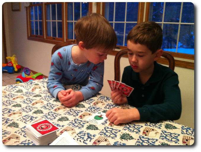 The younger brother helps the older brother choose which card to play on me