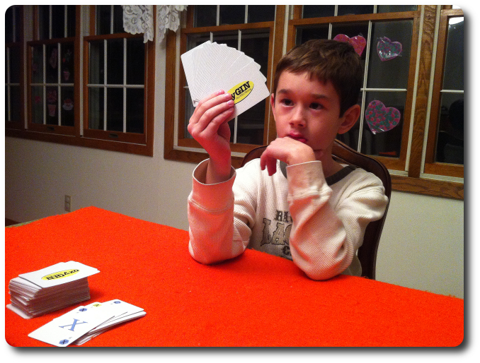 My little geek contemplates his cards as I take my turn