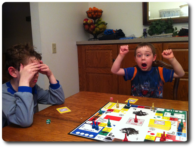 My 5-year-old shouts for joy as he wins the game - his older brother is noticeably upset