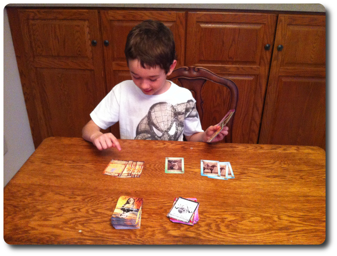 My little geek counts his cards during a particularly successful hand of cards