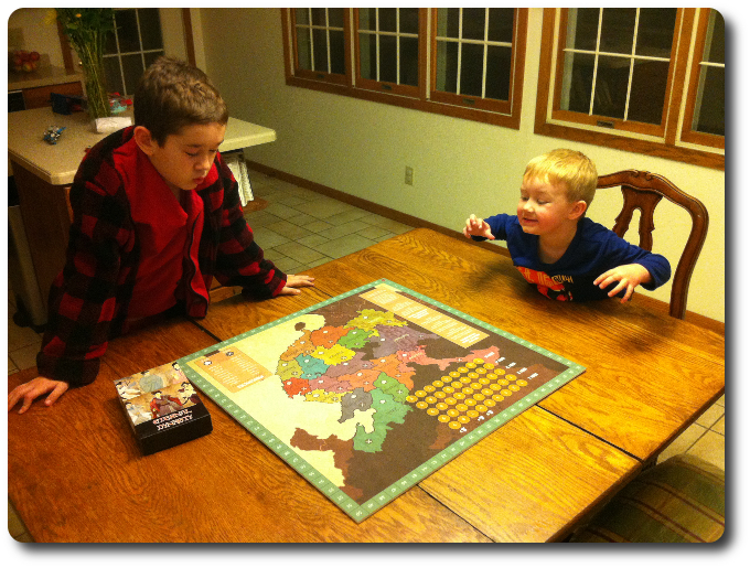 My oldest explains the game to his younger brother while he waits for me to play