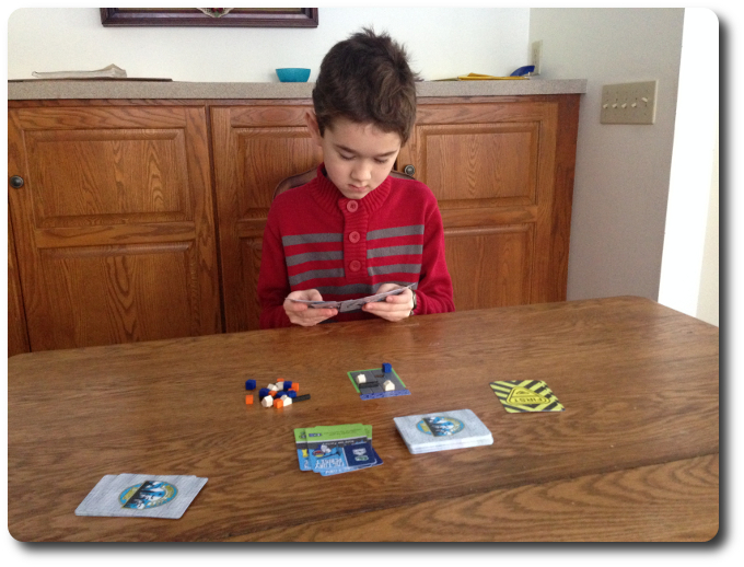 My little geek evaluates his cards - he elected to pass